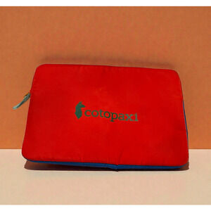 cotopaxi red laptop sleeve with blue trim